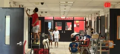 Dads and kids working in the main building's first-floor hallway